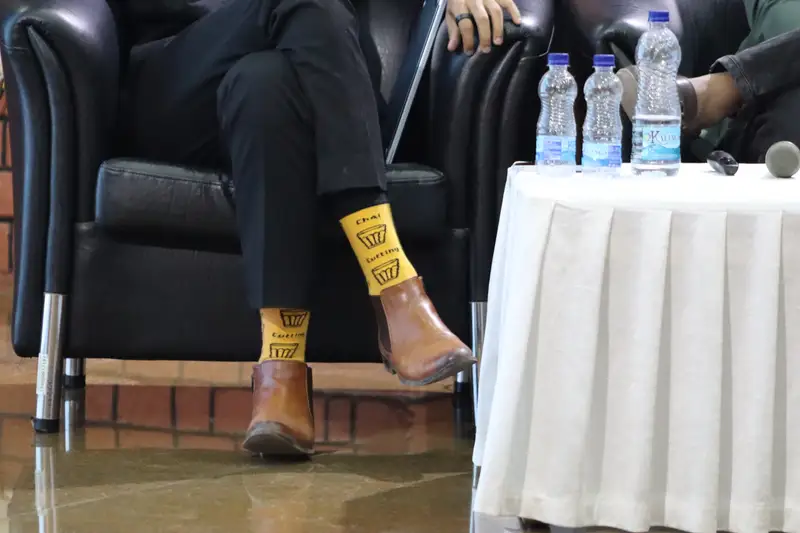 Bright yellow socks and brown boots at a panel discussion